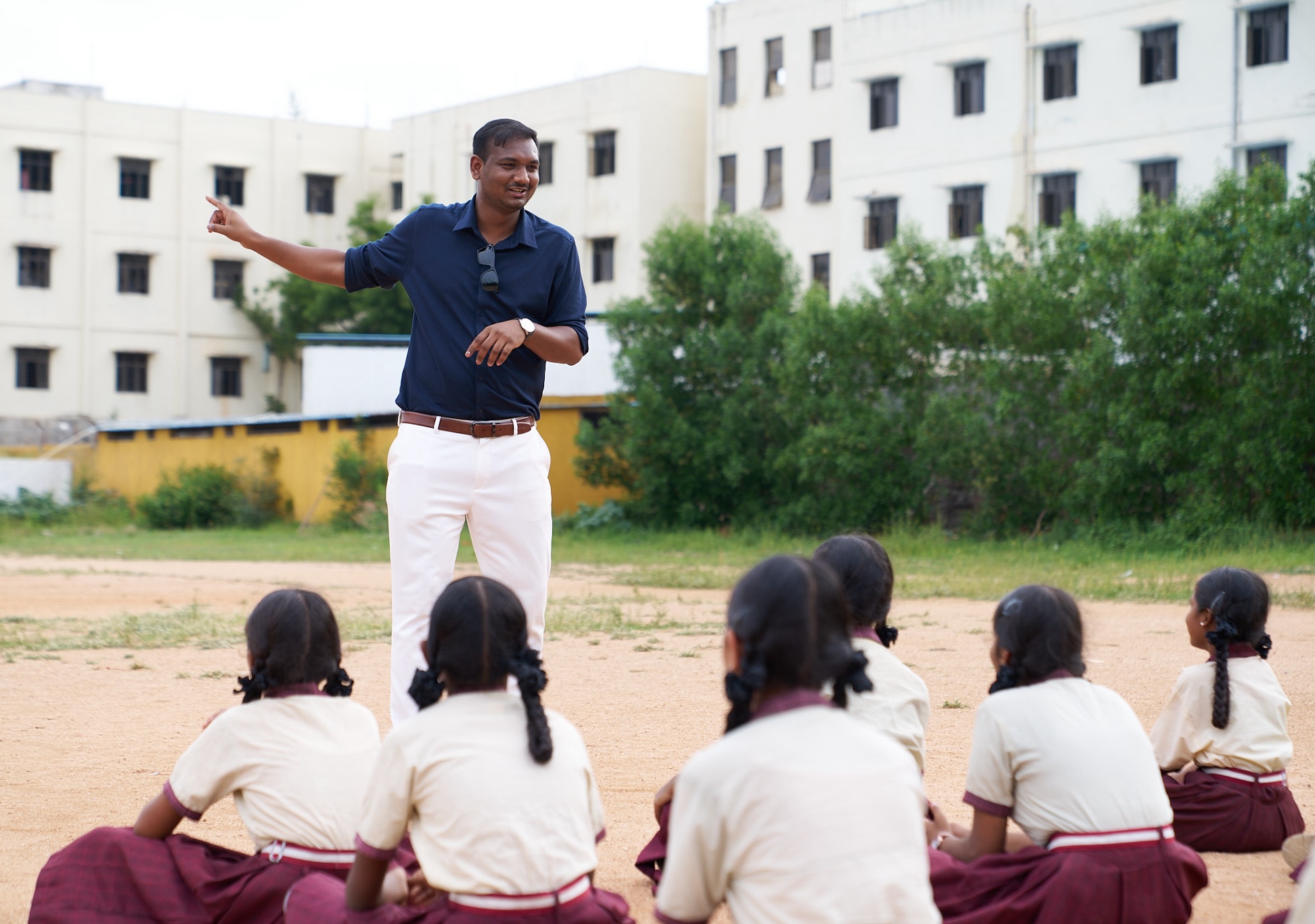 Saketh teaching children outside.