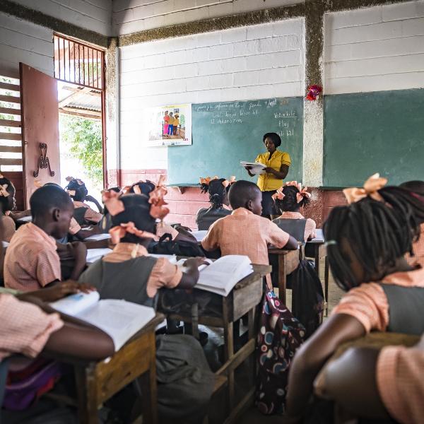 Children in classroom with teacher in Haiti.