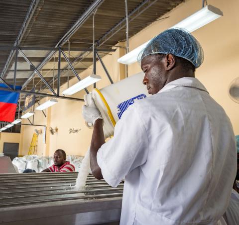 Man pouring salt in production facility in Haiti