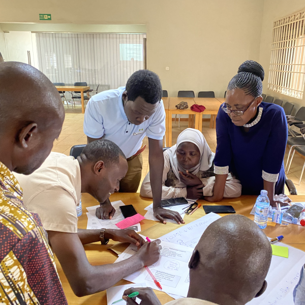 Teachers around desk in Uganda