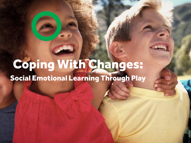 Children laughing with their arms around one another