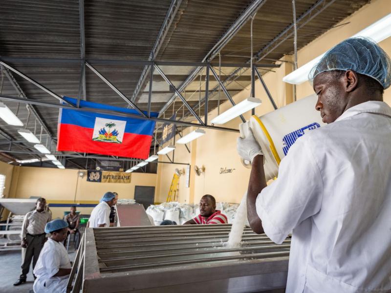 Man pouring salt in production facility