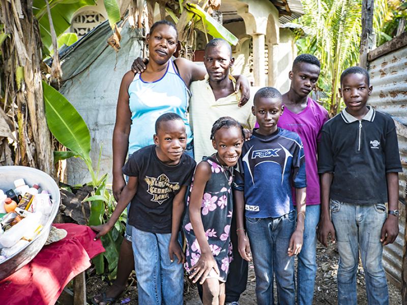 Haitian family in front of their home.